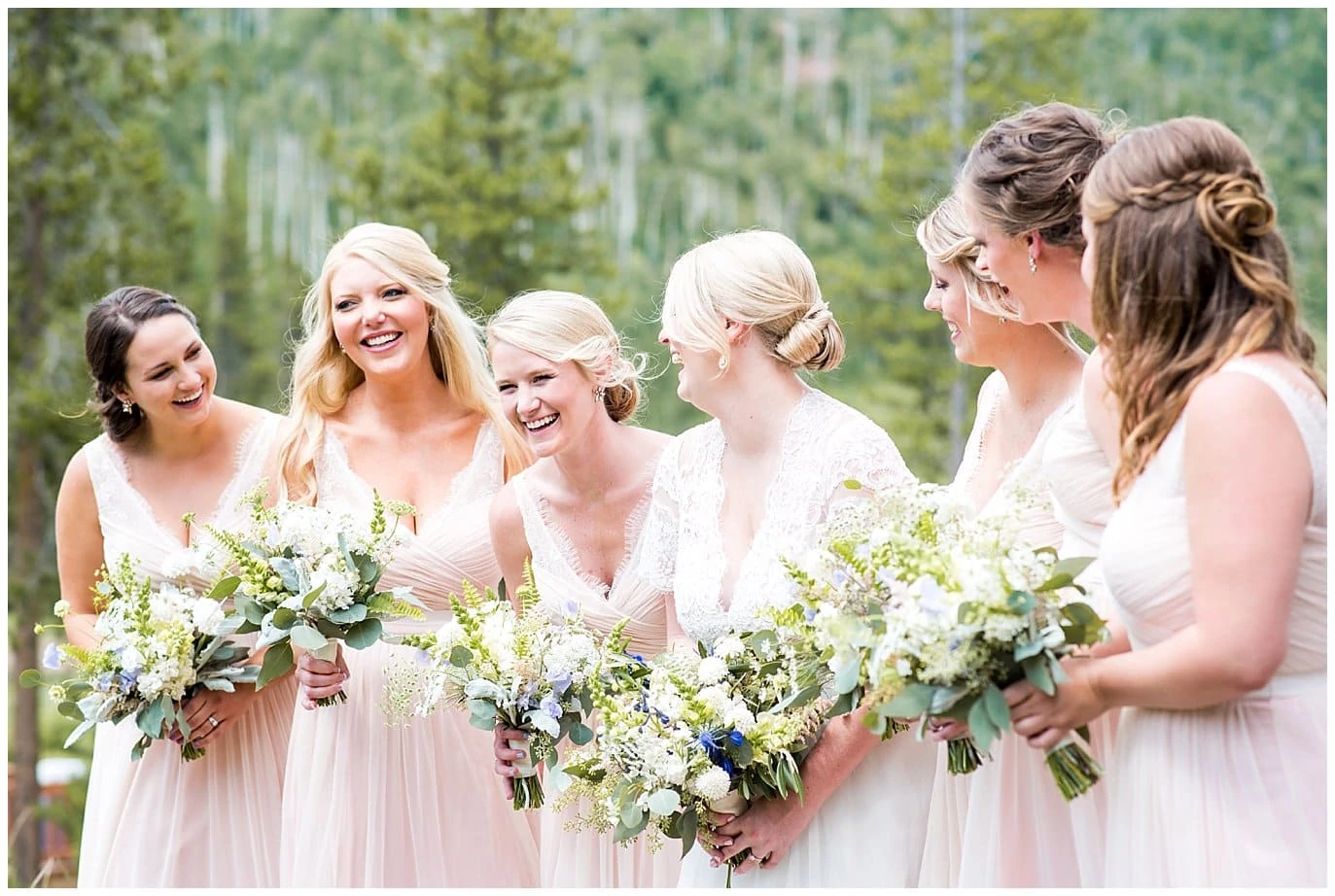 bride in lace dress and bridal party in pink at Piney River Ranch wedding by Beaver Creek Wedding photographer Jennie Crate, Photographer