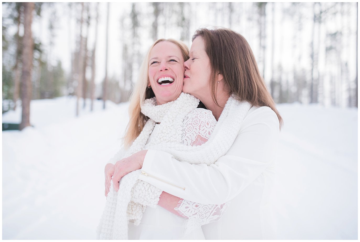two brides cuddle during cozy winter devil's thumb ranch elopement by LGBTQ wedding photographer Jennie Crate