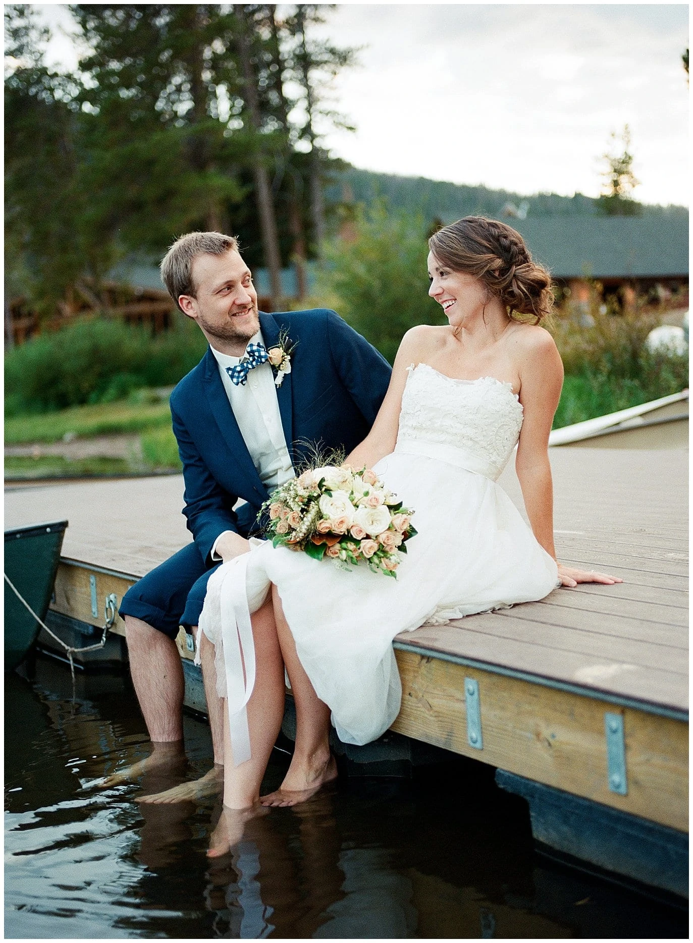 carefree colorado mountain lake wedding with bride and groom putting feet in lake at Piney River Ranch intimate wedding by Aspen wedding photographer Jennie Crate Photographer