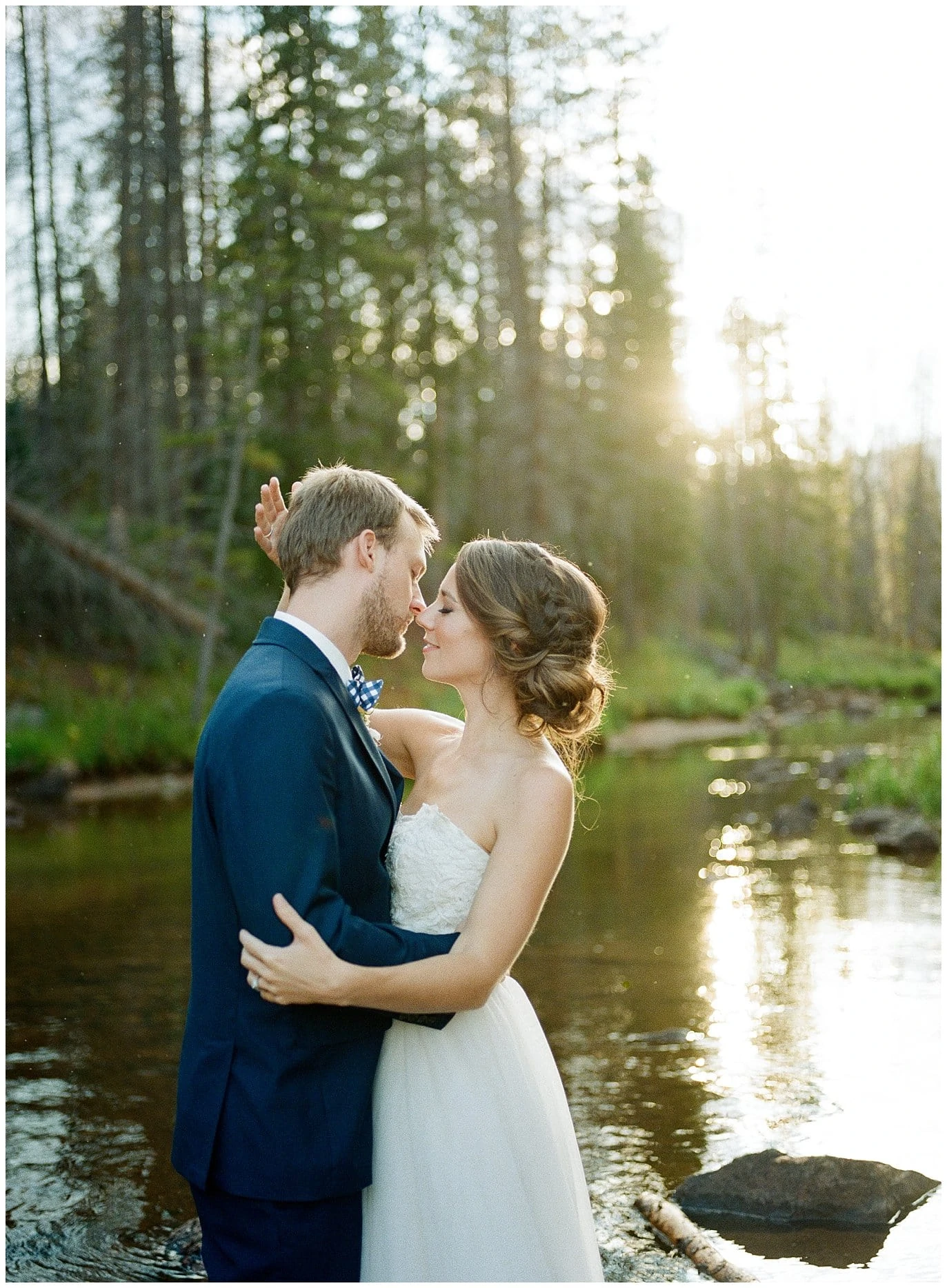 bride and groom wade in river at sunset on wedding day at Piney River Ranch intimate wedding by Aspen wedding photographer Jennie Crate Photographer 