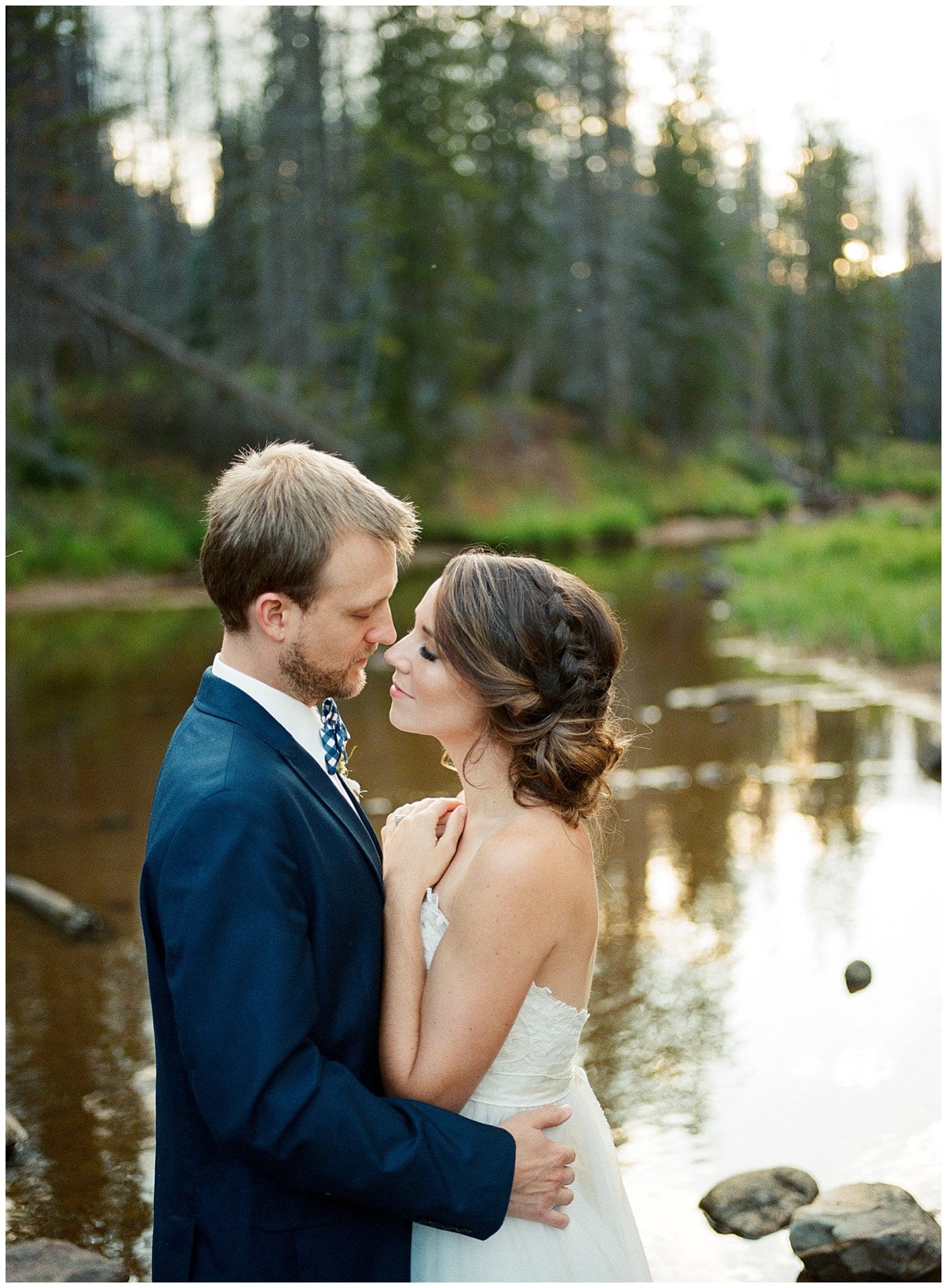 romantic kiss by colorado river on wedding day at Piney River Ranch intimate wedding by Beaver Creek wedding photographer Jennie Crate Photographer