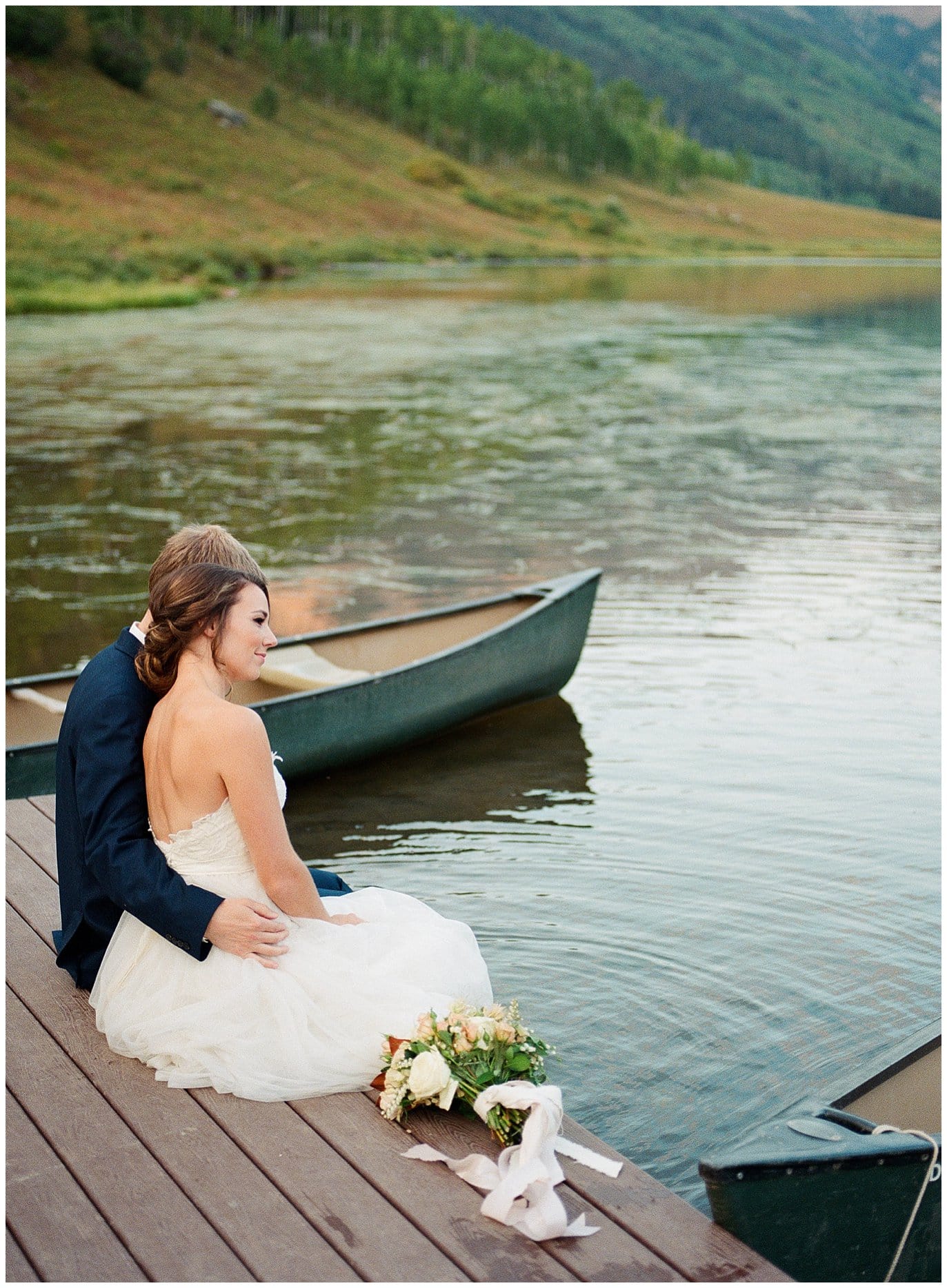 bride and groom with feet in lake at Piney River Ranch intimate wedding by Aspen wedding photographer Jennie Crate Photographer