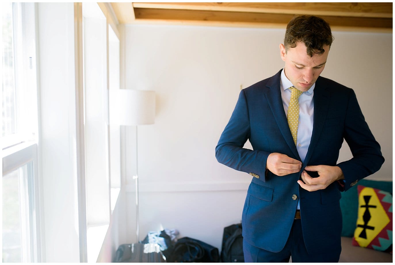 groom getting dressed in tiny house california photo