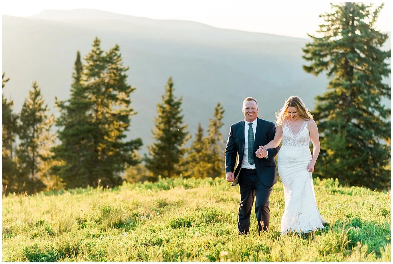 bride and groom at sunset on top of vail mountain photo