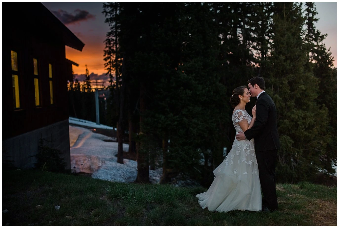 bride and groom cuddle at sunset at Timber Ridge Keystone Mountain Wedding 