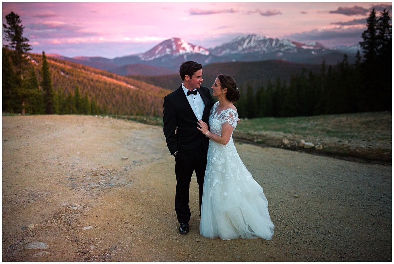 bride and groom at sunset with alpenglow mountain views at Timber Ridge Keystone Resort wedding by Keystone wedding photographer Jennie Crate