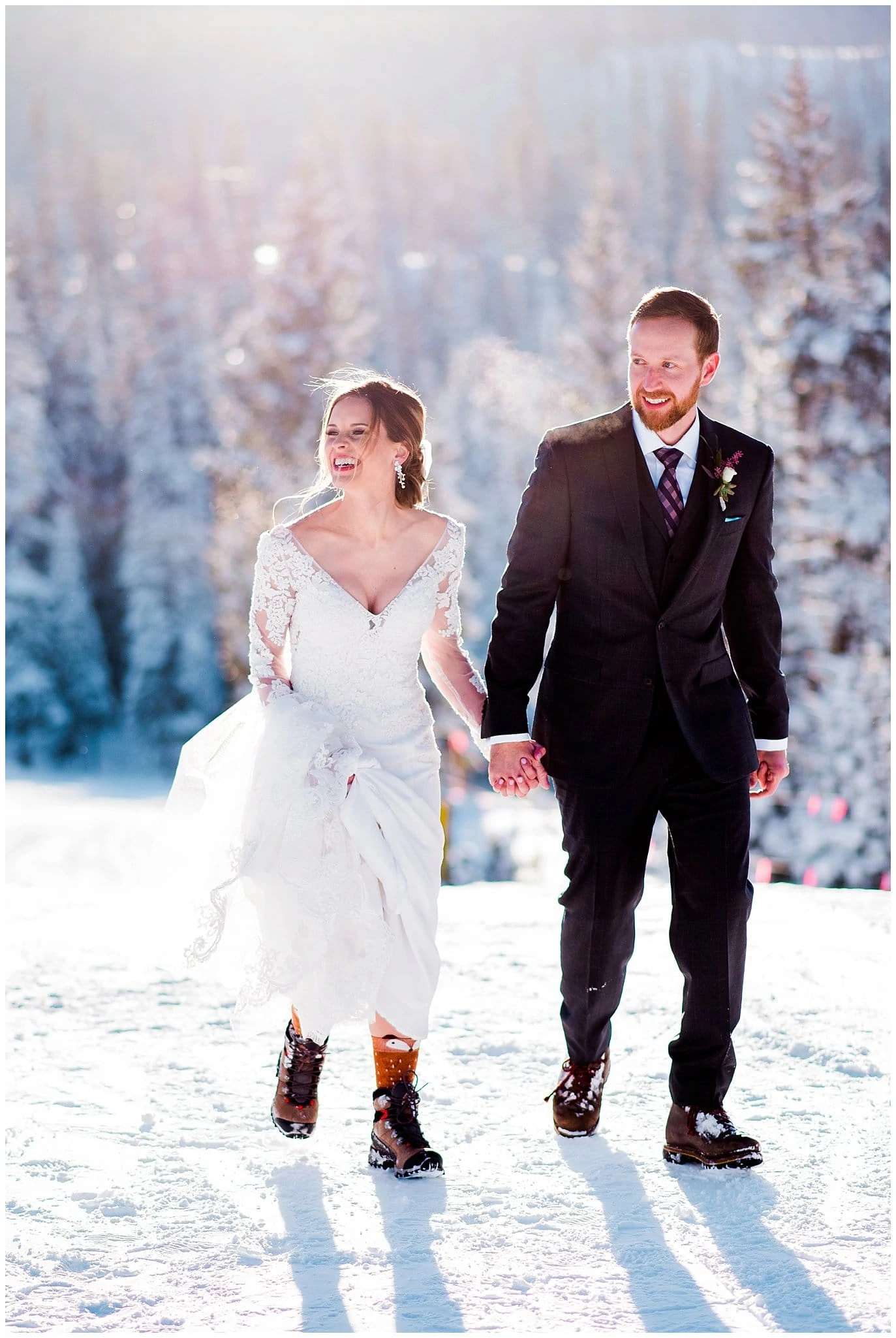 walking on mountaintop for winter wedding photo