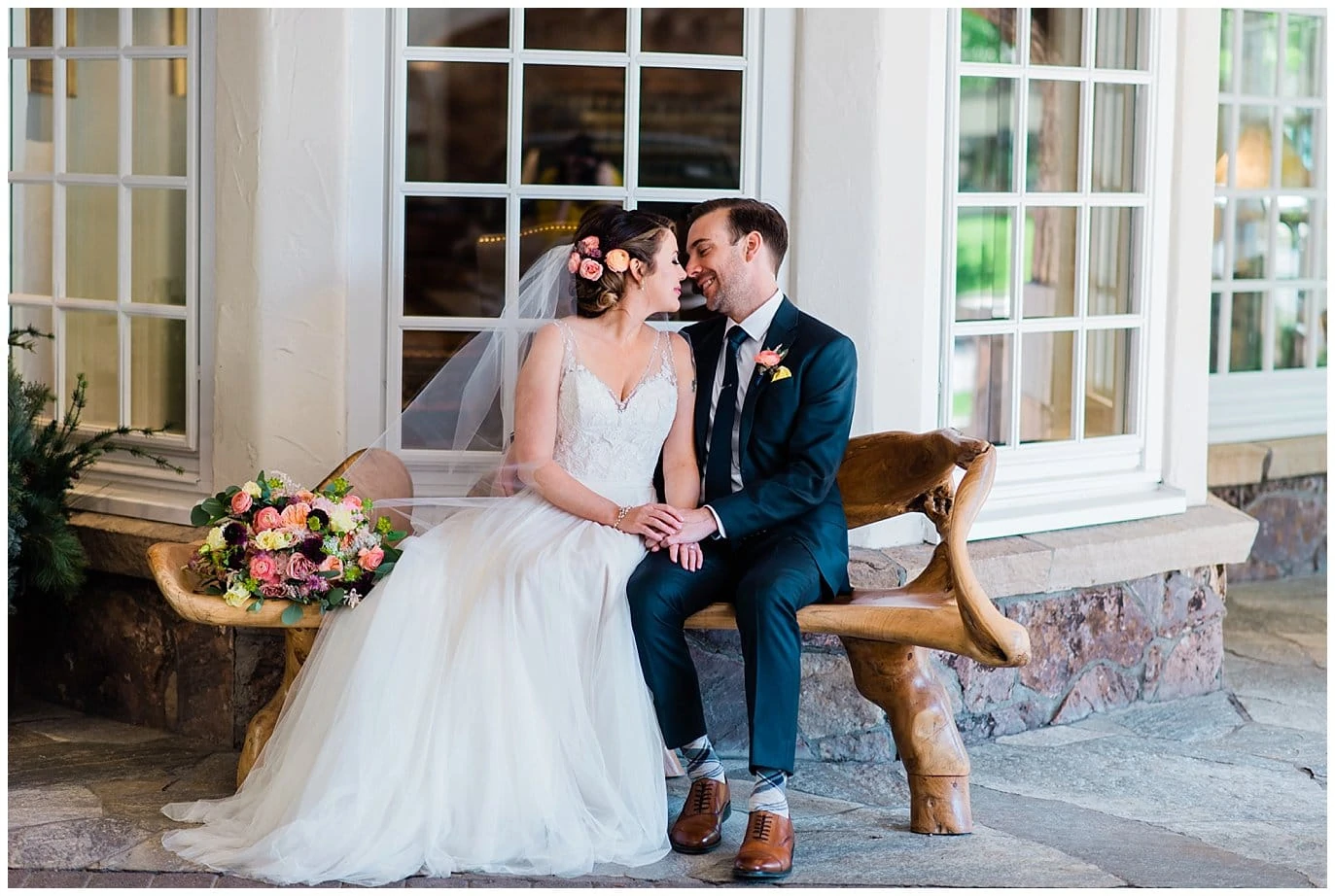 Bride and groom on bench at Sonnenalp Hotel Vail Colorado Wedding by Aspen Wedding Photographer Jennie Crate