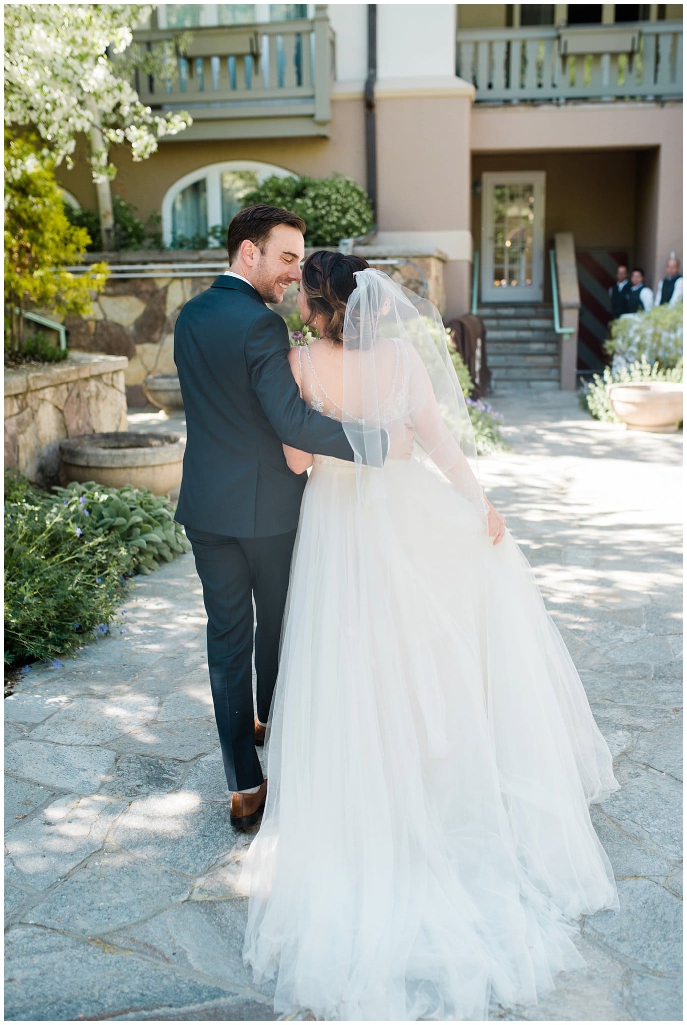 bride and groom walking away at Sonnenalp Hotel Vail Colorado Wedding by Denver Wedding Photographer Jennie Crate