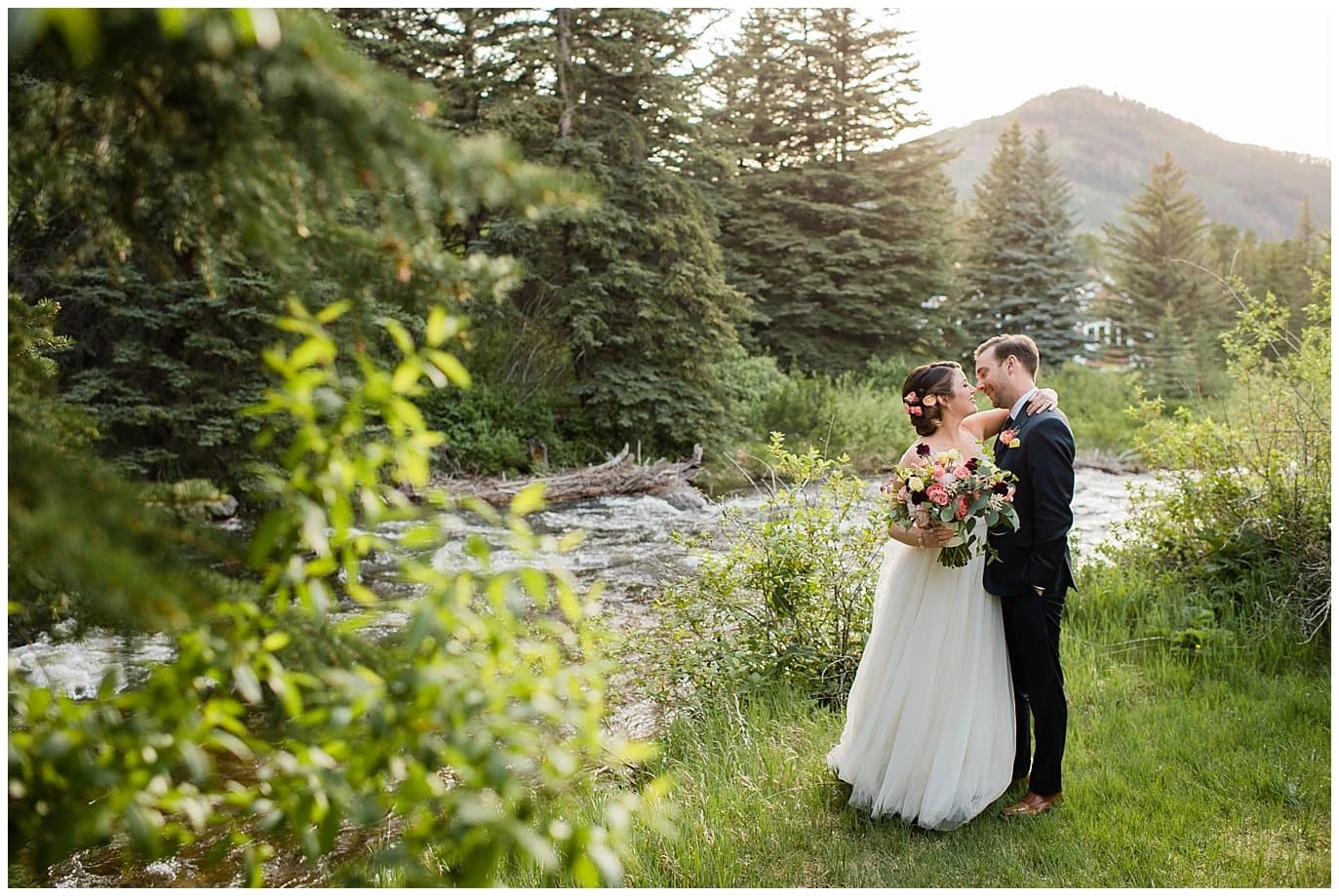 Bride and groom in rocky mountain forest at Sonnenalp Hotel Vail Colorado Wedding by Vail Wedding Photographer Jennie Crate