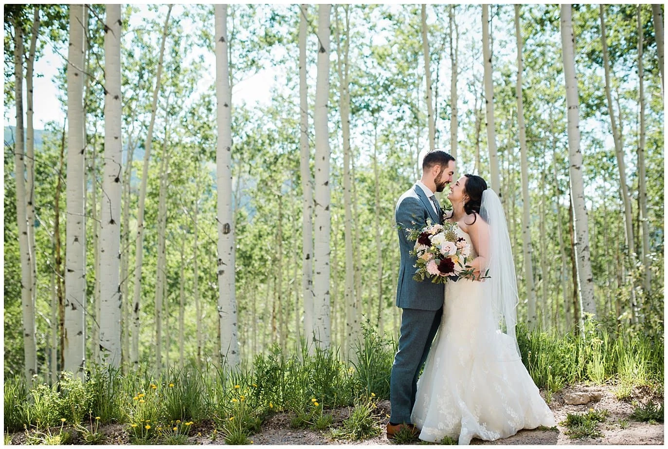 bride and groom in aspen trees outside Allie's Cabin wedding in Beaver Creek