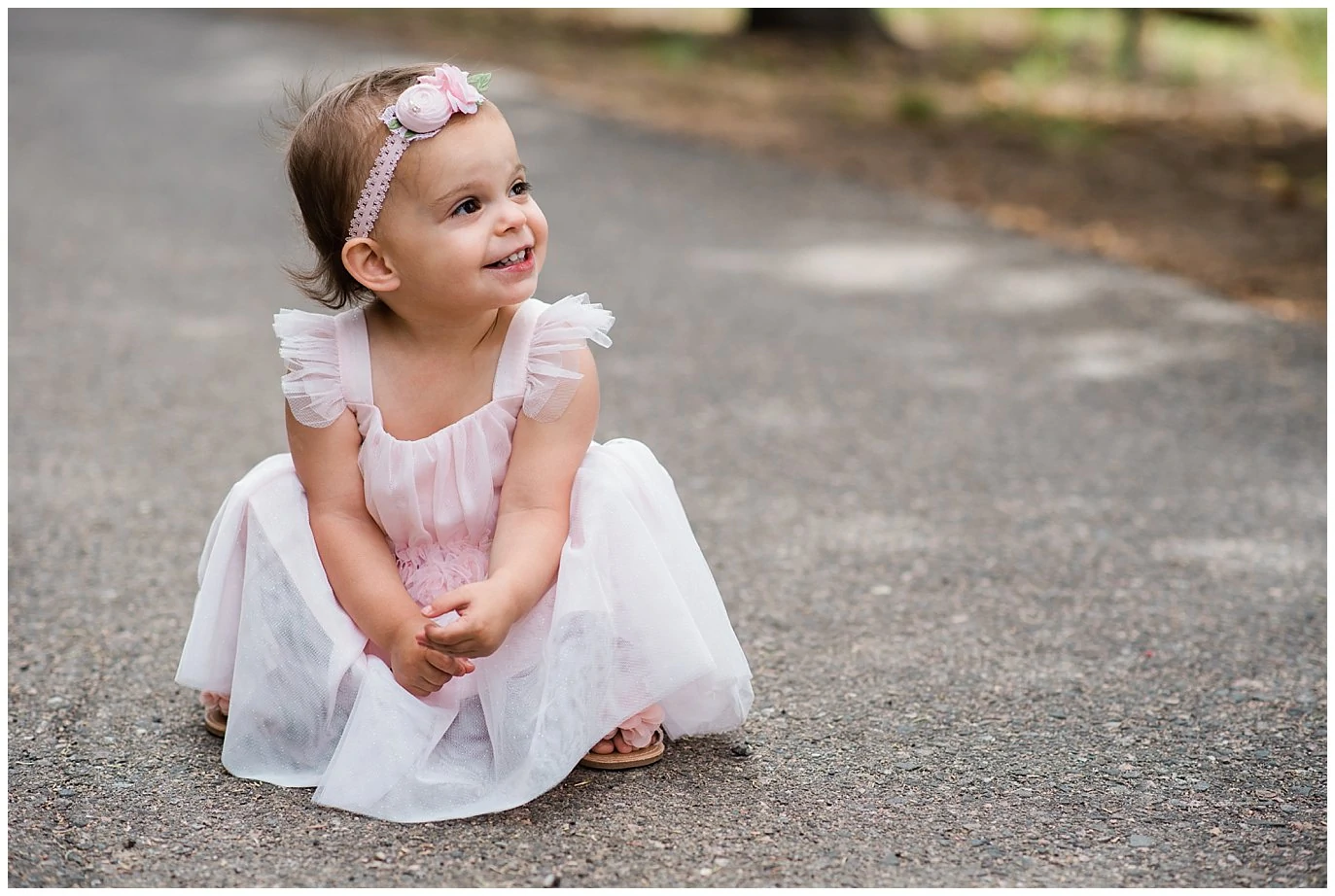 flower girl in pink tulle dress at Deer Creek Valley Ranch wedding by Conifer Wedding Photographer Jennie Crate Photographer