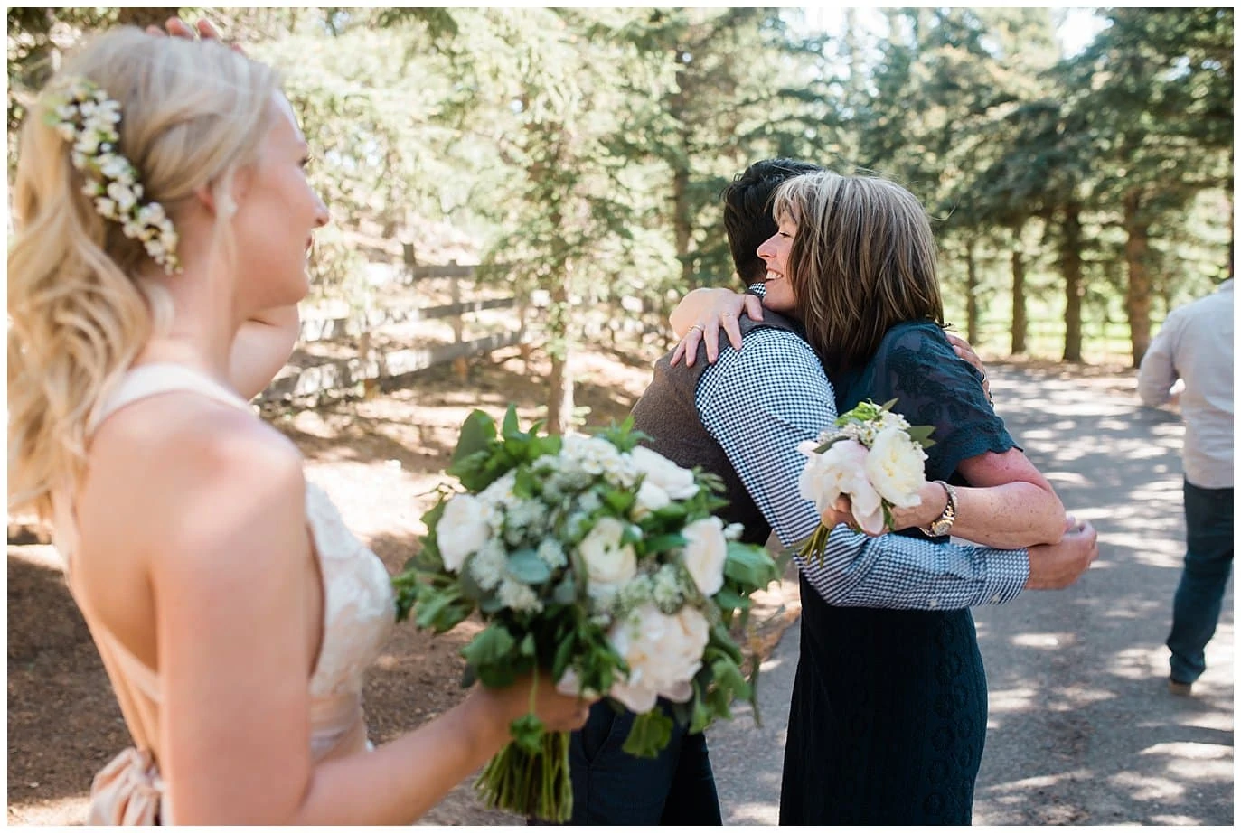 groom hugs mom after ceremony at Deer Creek Valley Ranch wedding by Conifer Wedding Photographer Jennie Crate Photographer