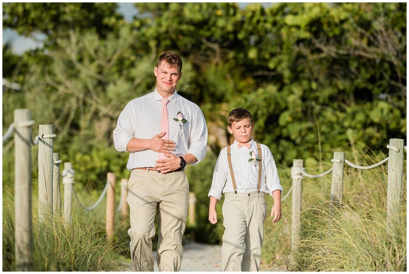 Groom and son walking down island beach wedding photo