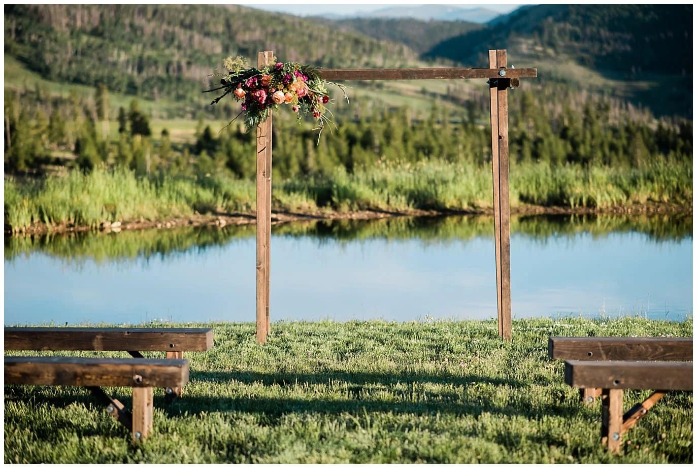 Wooden arch and wooden ceremony bench photo