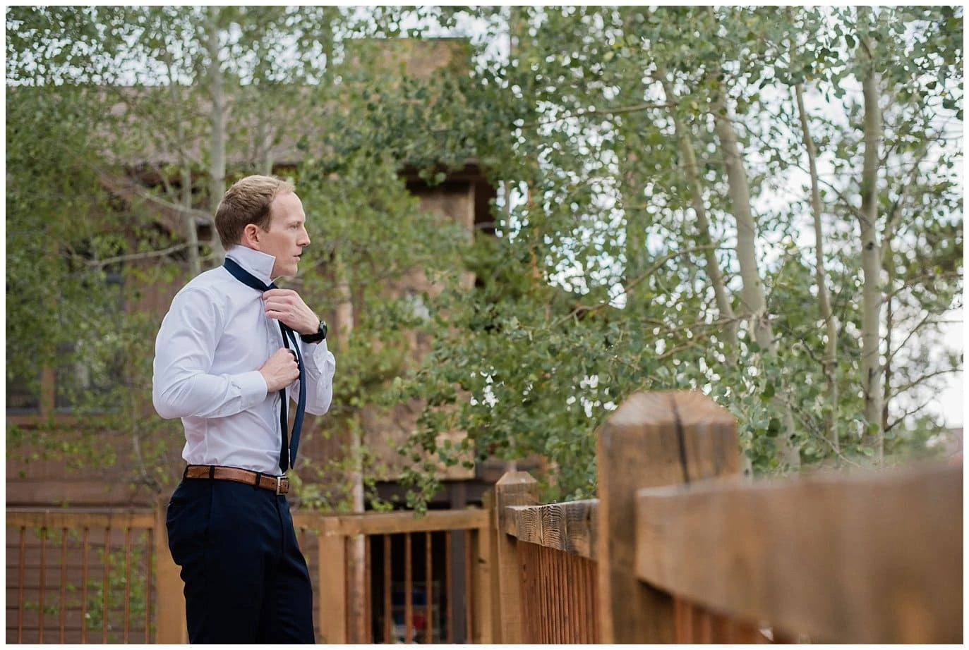 groom getting ready on deck of private home at Arapahoe Basin Black Mountain Lodge Wedding by Keystone Wedding Photographer Jennie Crate