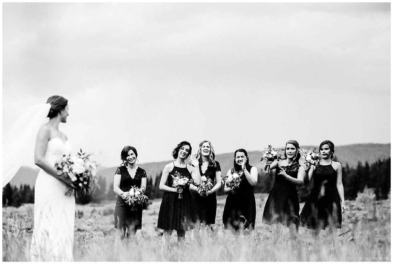 bride and bridesmaids in fields at Arapahoe Basin Black Mountain Lodge Wedding by Dillon Wedding Photographer Jennie Crate