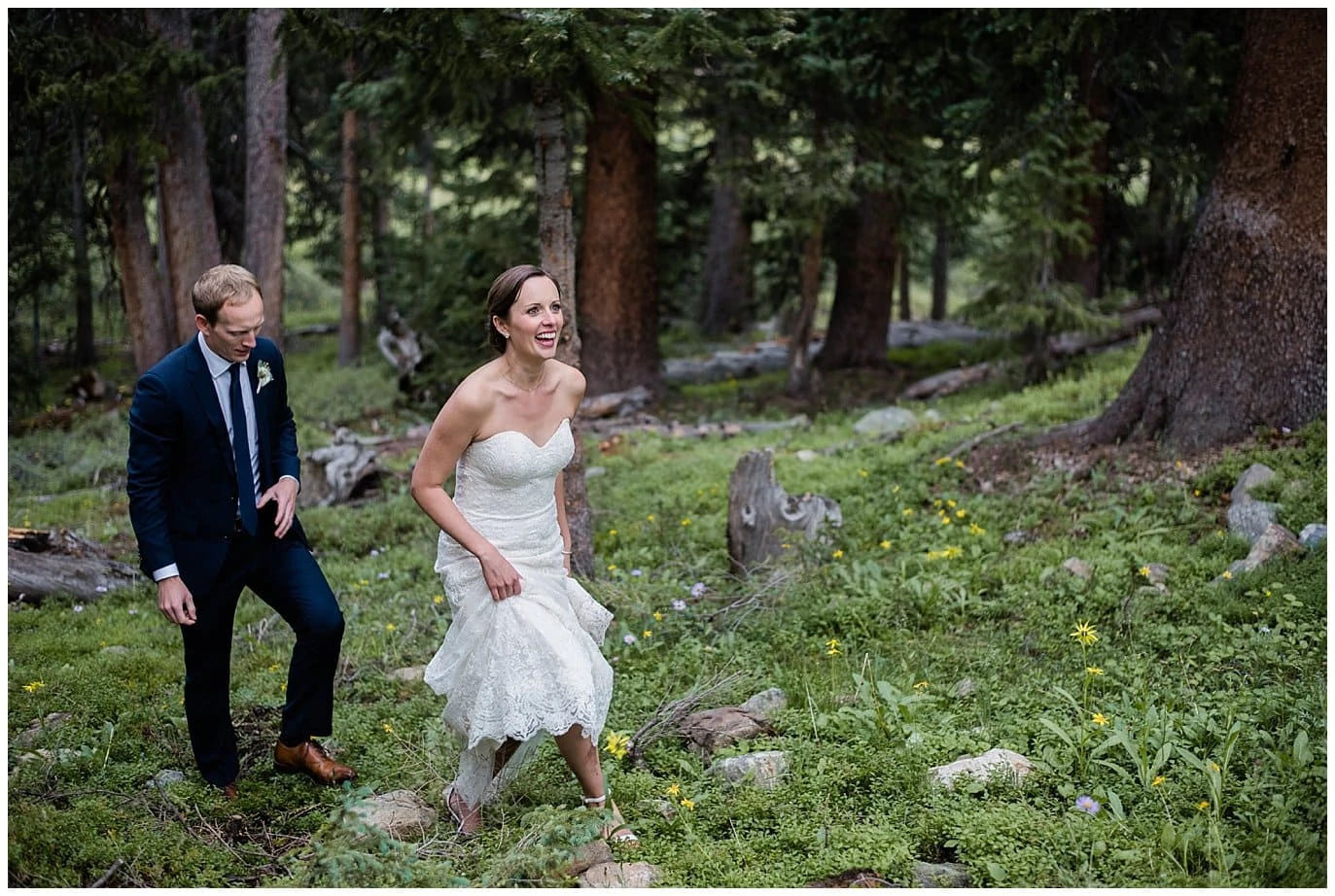 bride and groom walking through lush forests at Black Mountain Lodge wedding photo