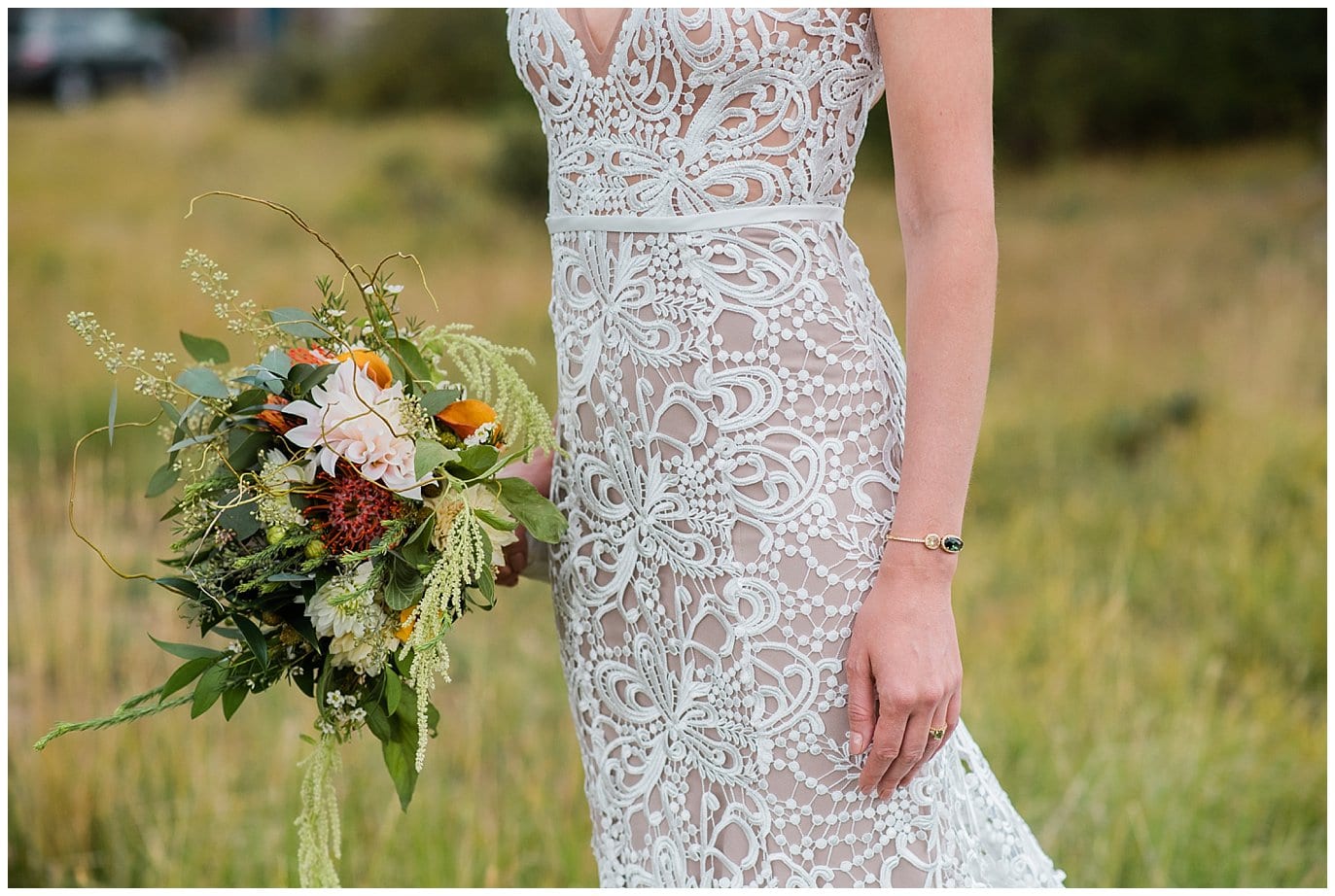 Lace and nude slim wedding dress with green bracelet photo