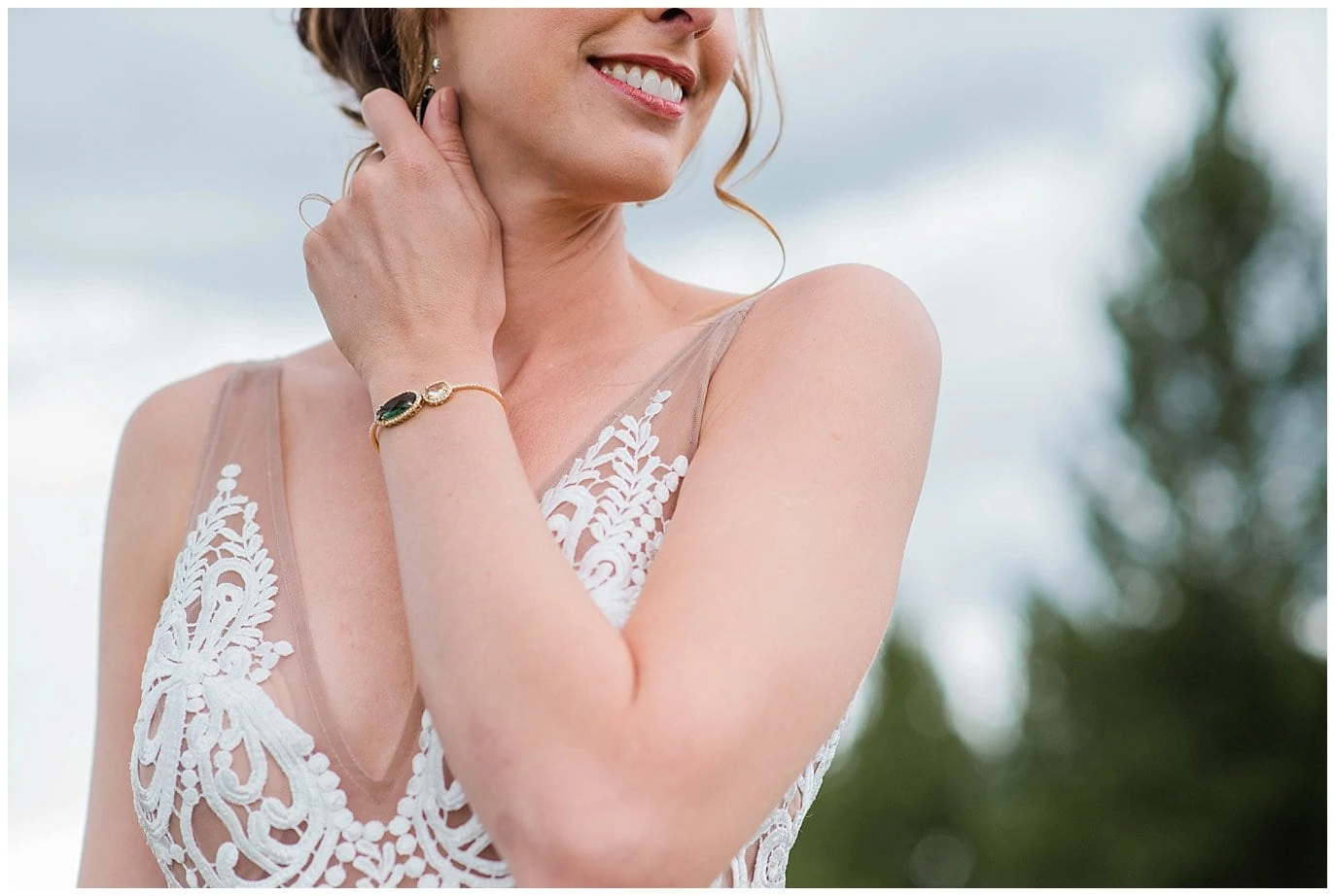 bride in lace dress with emerald wedding bracelet photo