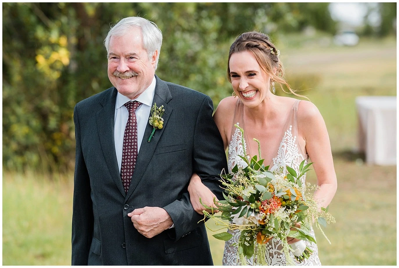 excited bride walks down aisle with father at Winding River Ranch Wedding photo