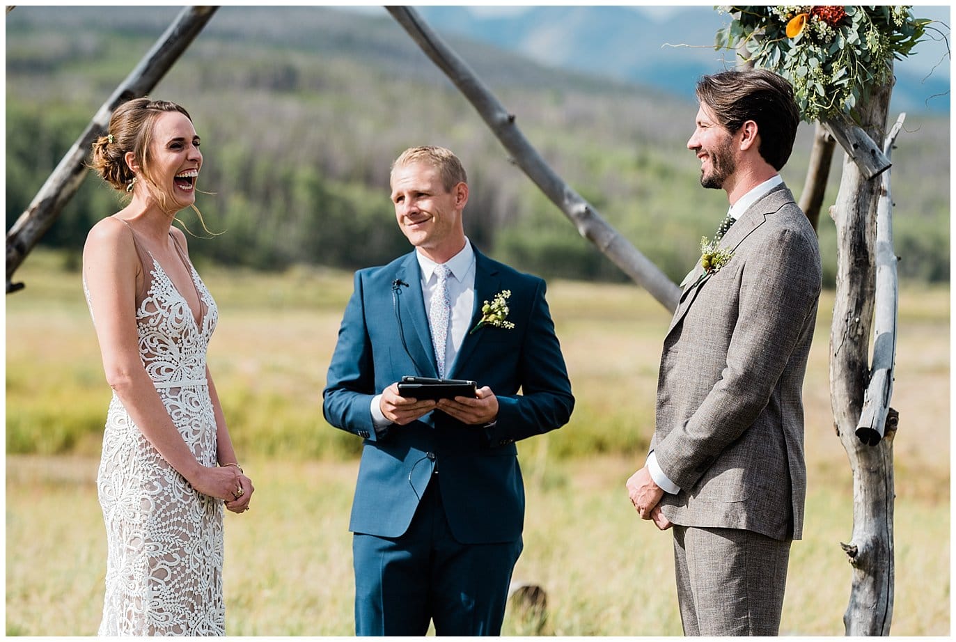 bride laughing at alter at colorado ranch wedding photo