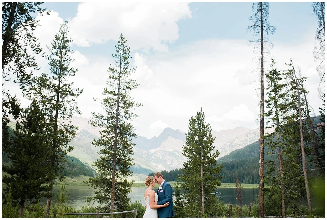 bride and groom cuddle in front of lake at Piney River Ranch Summer Wedding by Piney River Ranch wedding photographer Jennie Crate photographer