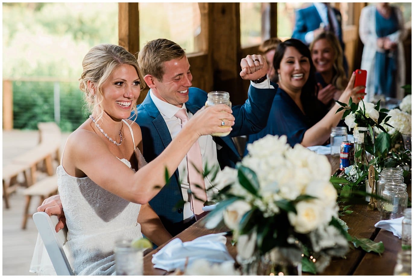 groom fist pumps during toasts at intimate Piney River Ranch Summer Wedding by Beaver Creek wedding photographer Jennie Crate photographer