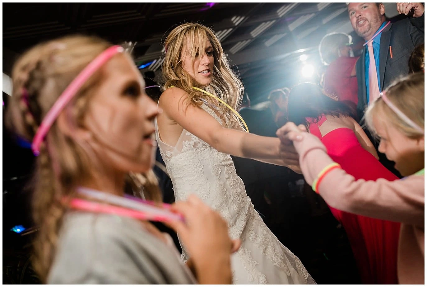 bride dancing with flower girls photo
