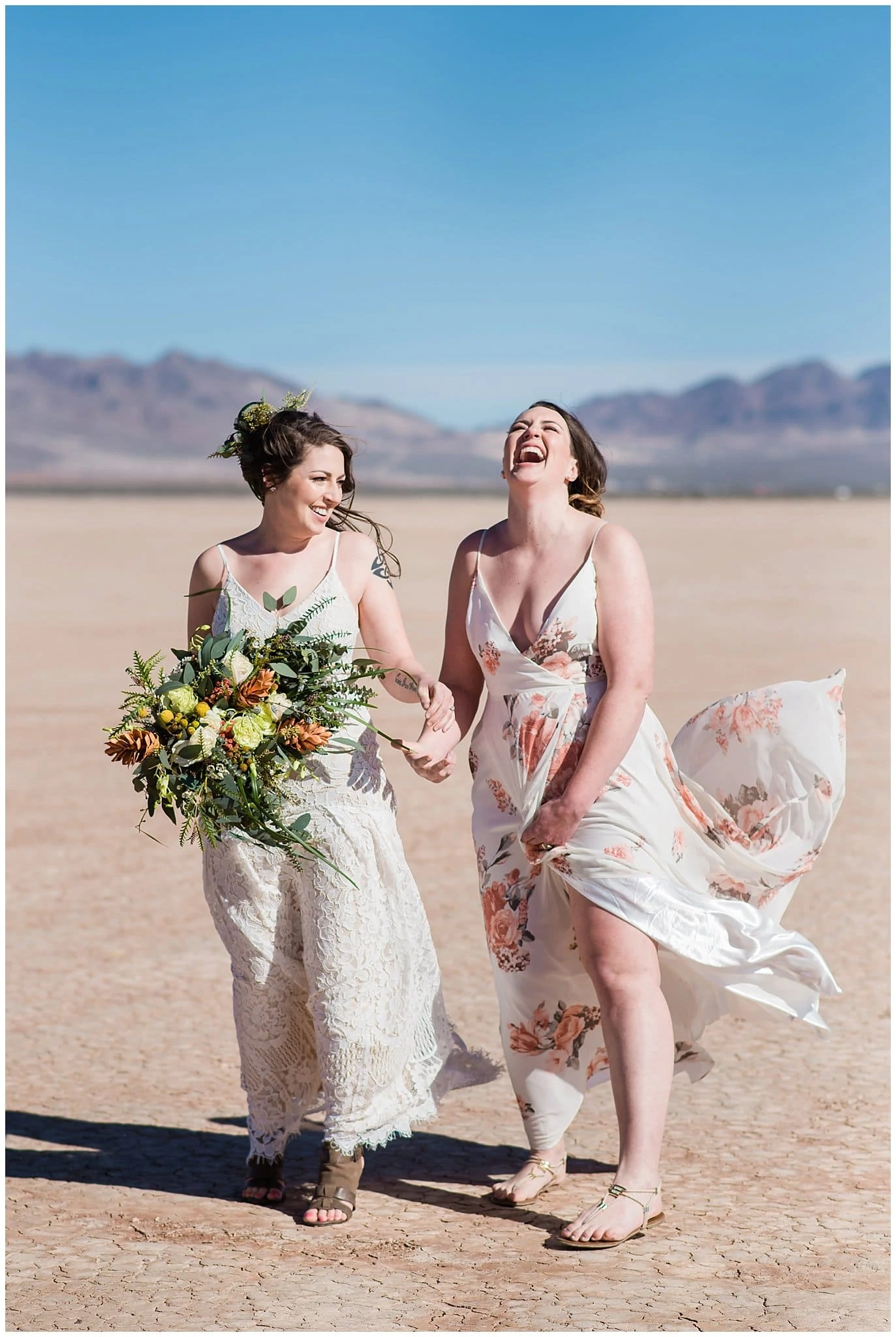 joyful brides laughing at Nevada dry lake beds elopement by Las Vegas elopement photographer Jennie Crate