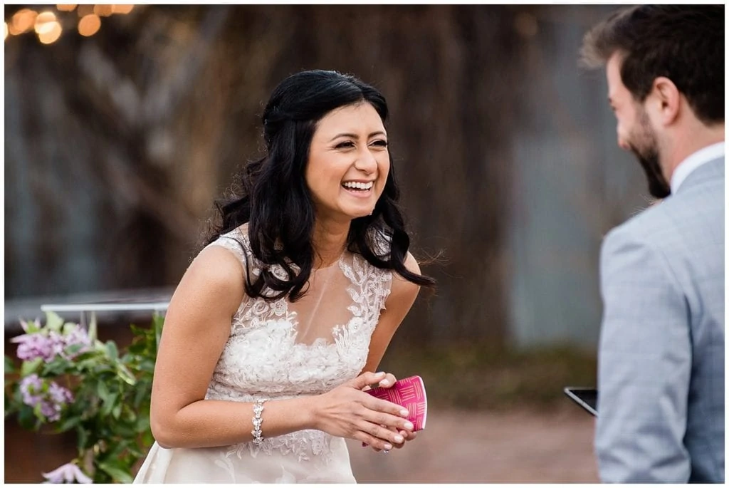 bride laughing during vows at blanc Denver photo