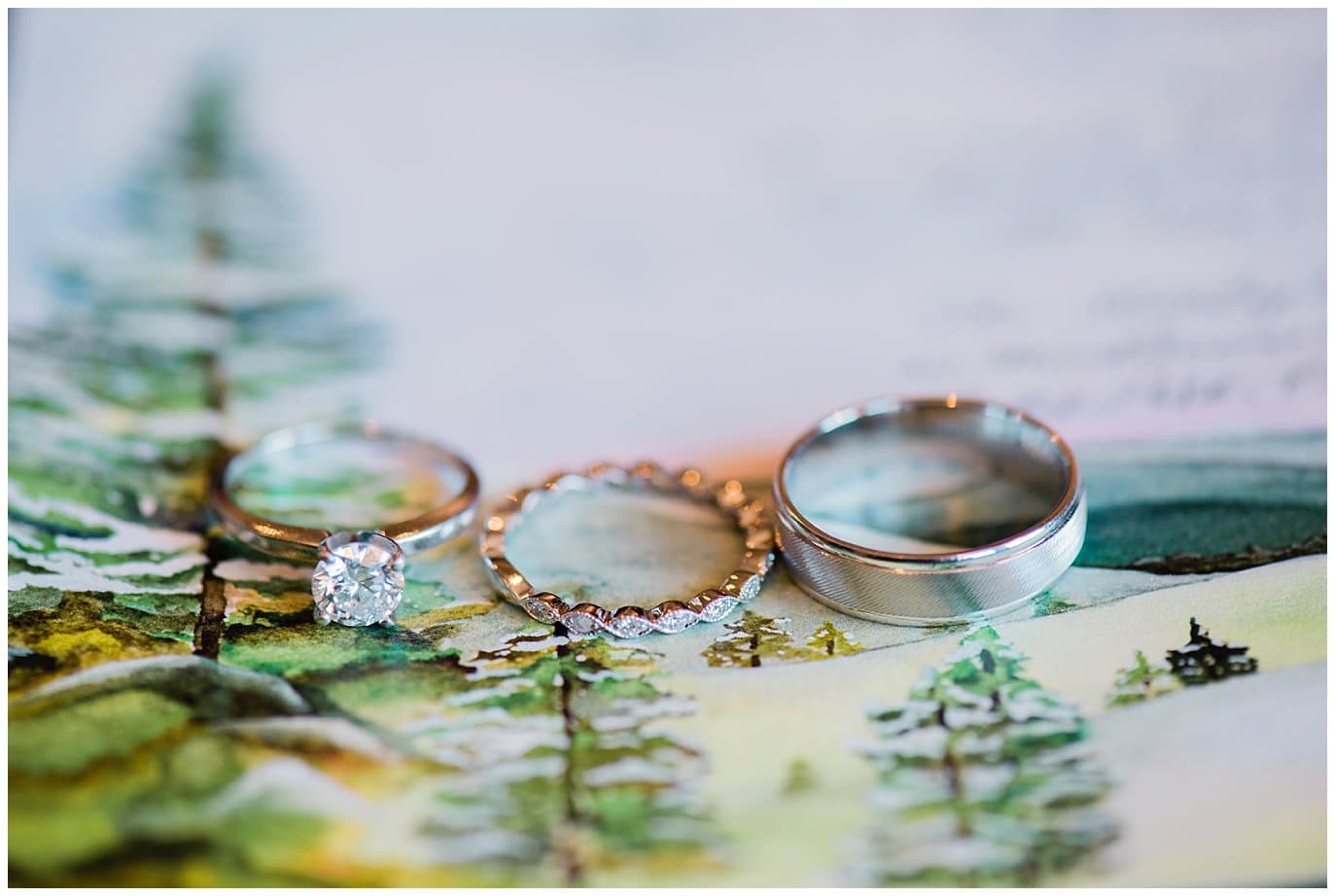 Engagement ring, diamond wedding band, and groom wedding band photo