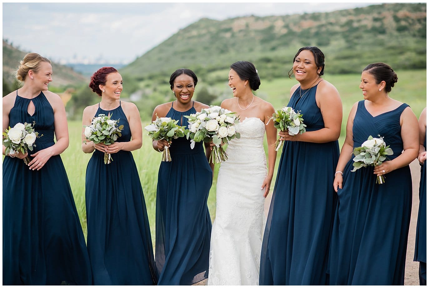 bride with bridesmaids in navy dresses photo