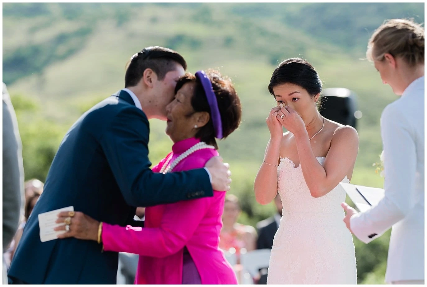 groom hugs mom while emotional bride looks on Colorado wedding photo