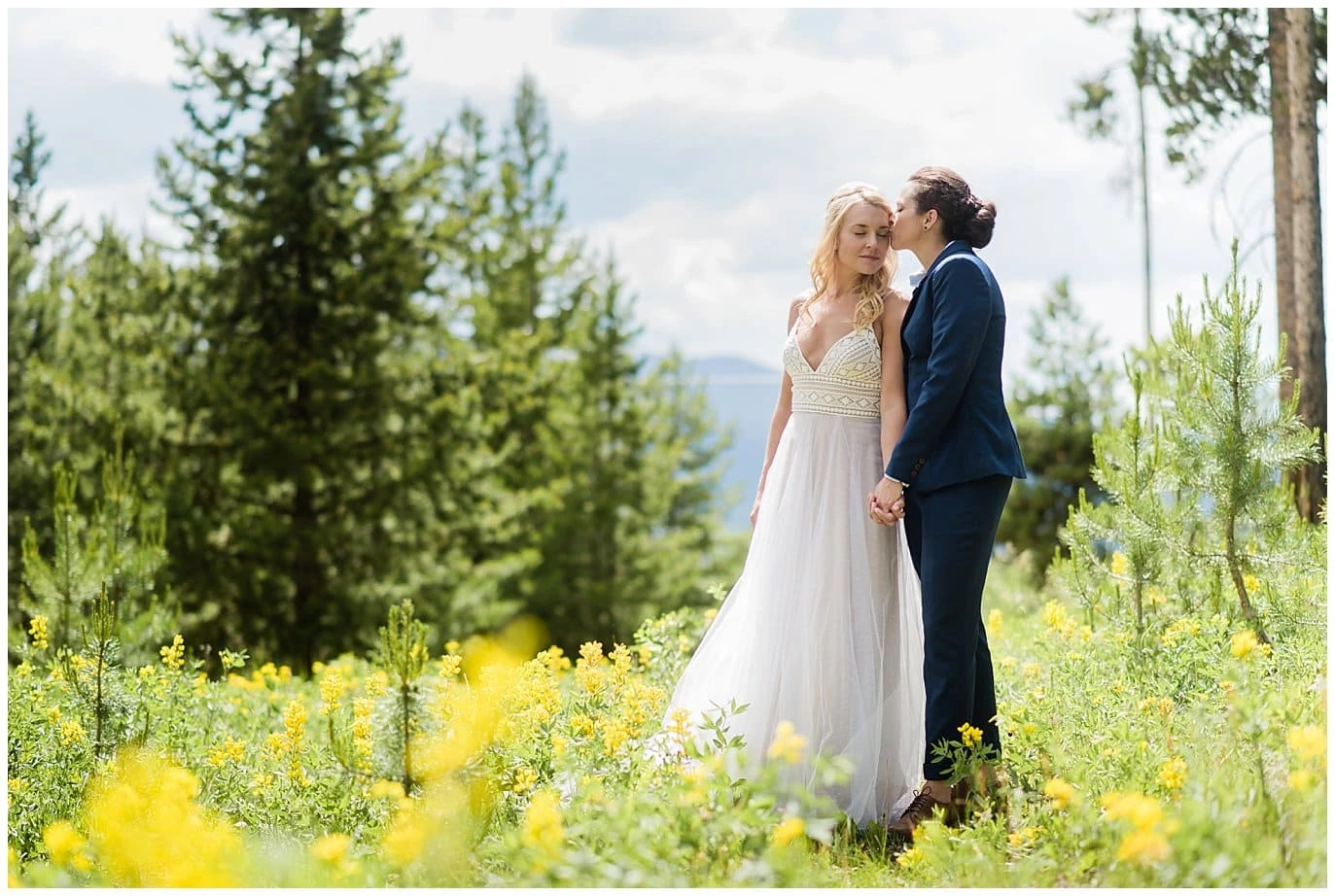 two brides in field of wild flowers Winter Park wedding photo