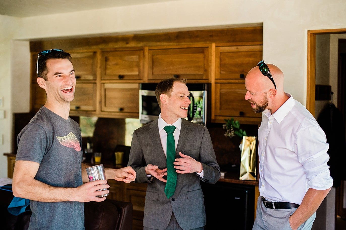 groom relaxed after getting dressed with groomsmen at private Fraser VRBO by Tabernash Wedding Photographer Jennie Crate