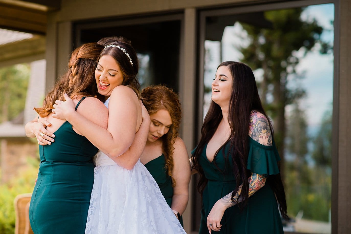 bride and friends embrace after she gets in wedding dress before B Lazy 2 Ranch wedding by Fraser Wedding Photographer Jennie Crate