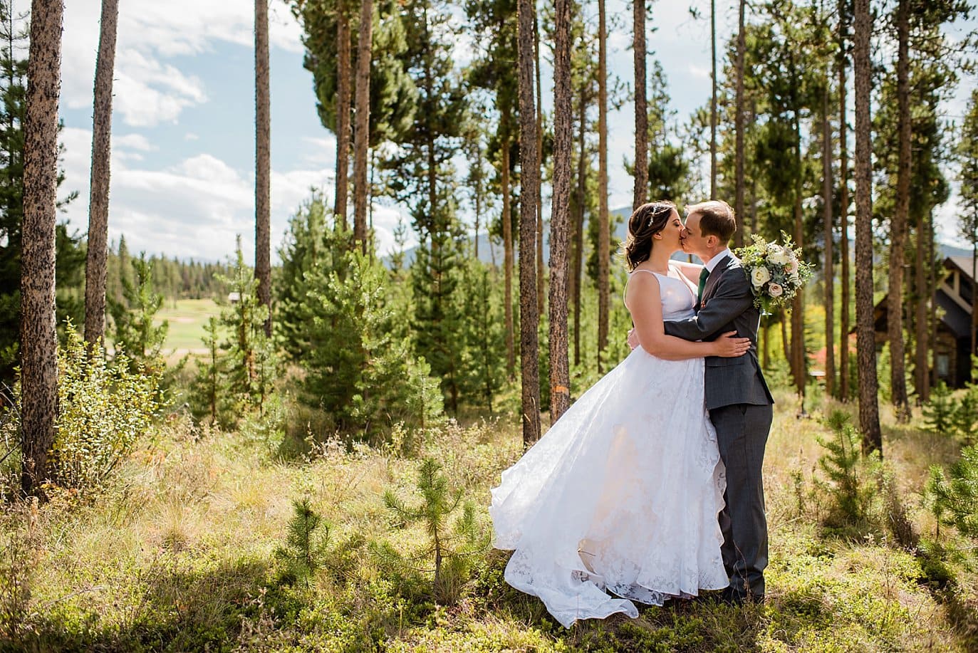 bride and groom in evergreen trees at B Lazy 2 Ranch wedding by Denver Wedding Photographer Jennie Crate