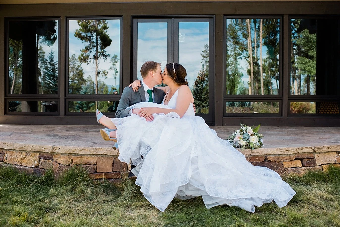 bride and groom cuddling on steps before B Lazy 2 Ranch wedding by Denver Wedding Photographer Jennie Crate, Photographer