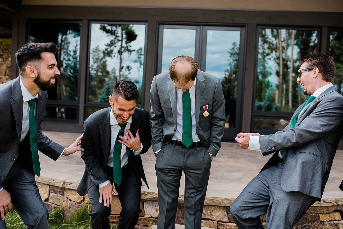 groomsmen laughing at B Lazy 2 Ranch wedding by Fraser wedding photographer Jennie Crate