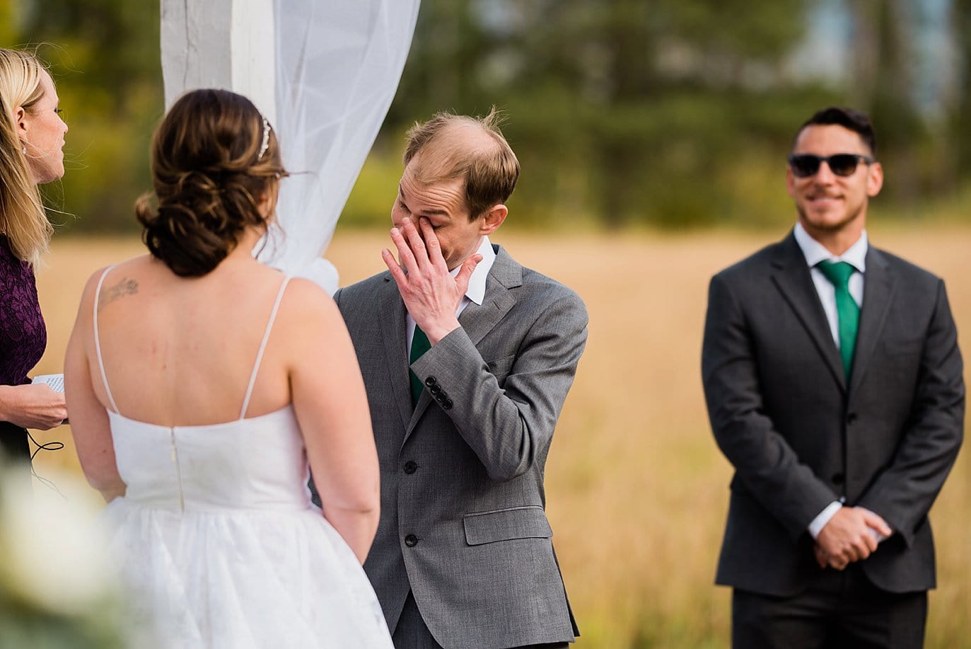 groom cries during vows at B Lazy 2 Ranch wedding by Tabernash wedding photographer Jennie Crate