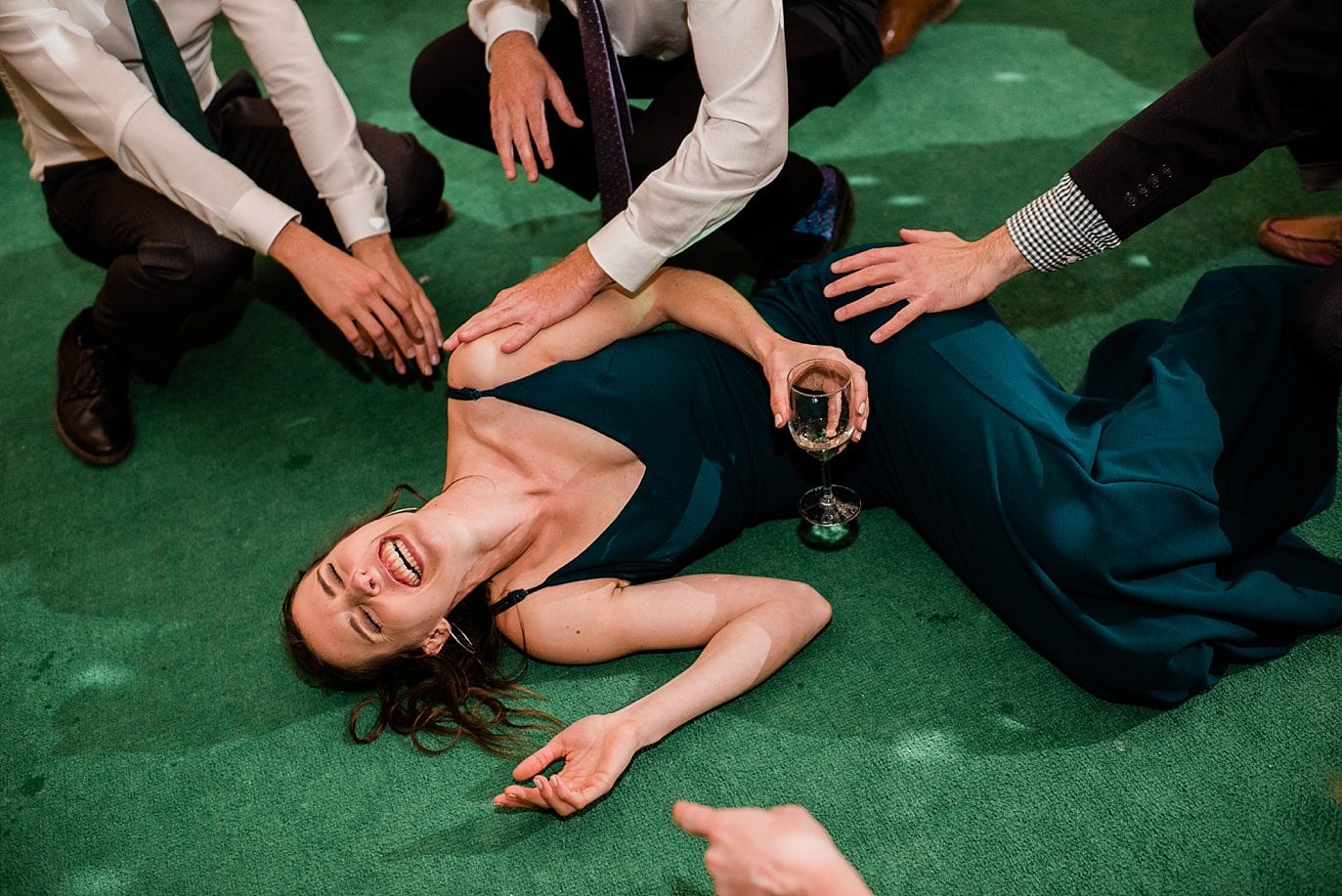 bridesmaid on floor during reception dancing at B Lazy 2 Ranch by Fraser wedding photographer Jennie Crate