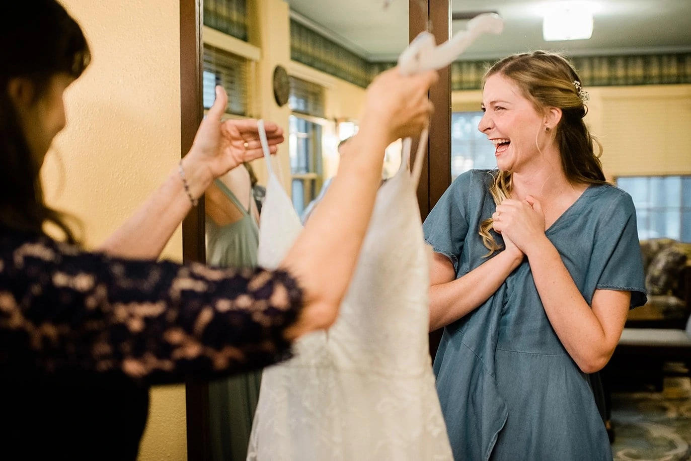 bride excited to put her dress on a colorado outdoor wedding