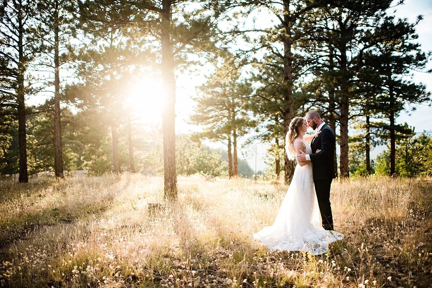 intimate sunset photo of bride and groom in the evergreen trees at Boettcher Mansion