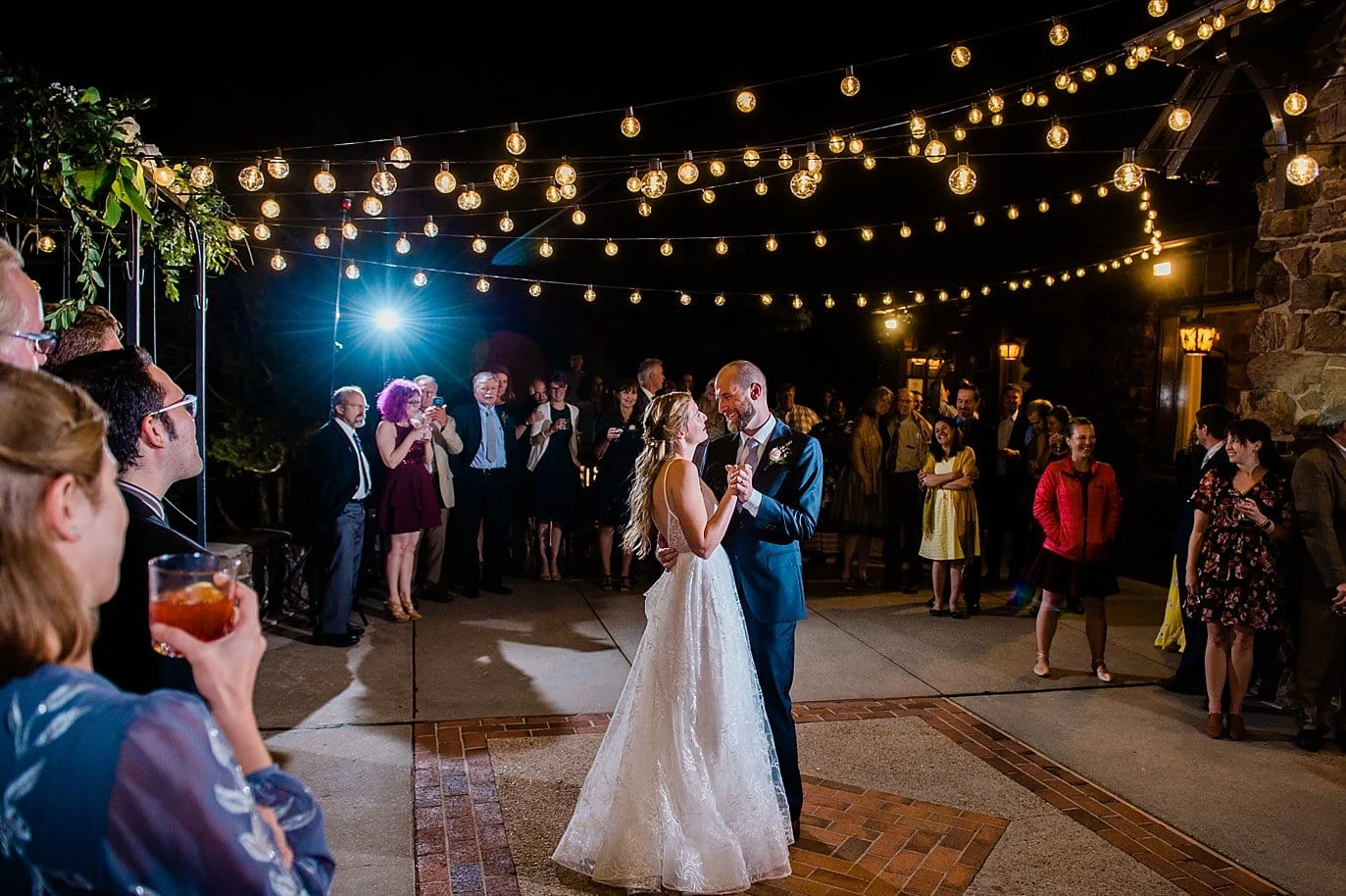 first dance on outdoor patio under market lights in golden colorado wedding