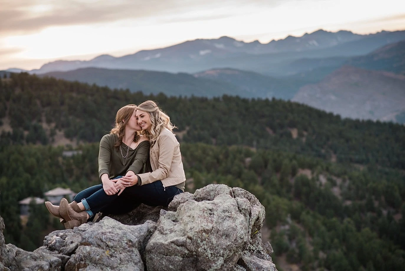 lesbian couple cuddles at top of Lost Gulch Lookout by Boulder wedding photographer Jennie Crate