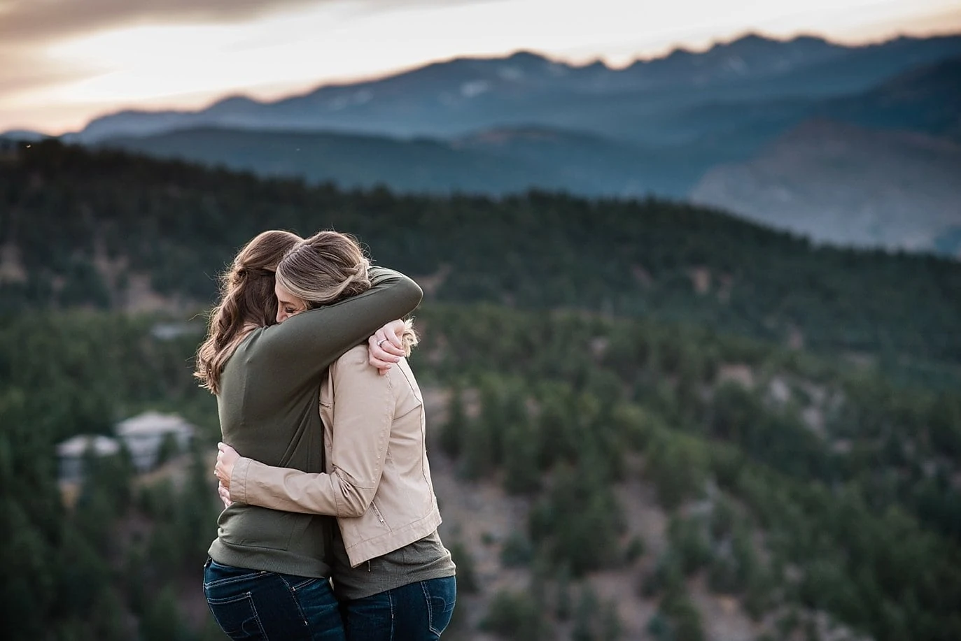 intimate moment between same-sex couple at top of Lost Gulch Lookout by Estes park wedding photographer Jennie Crate