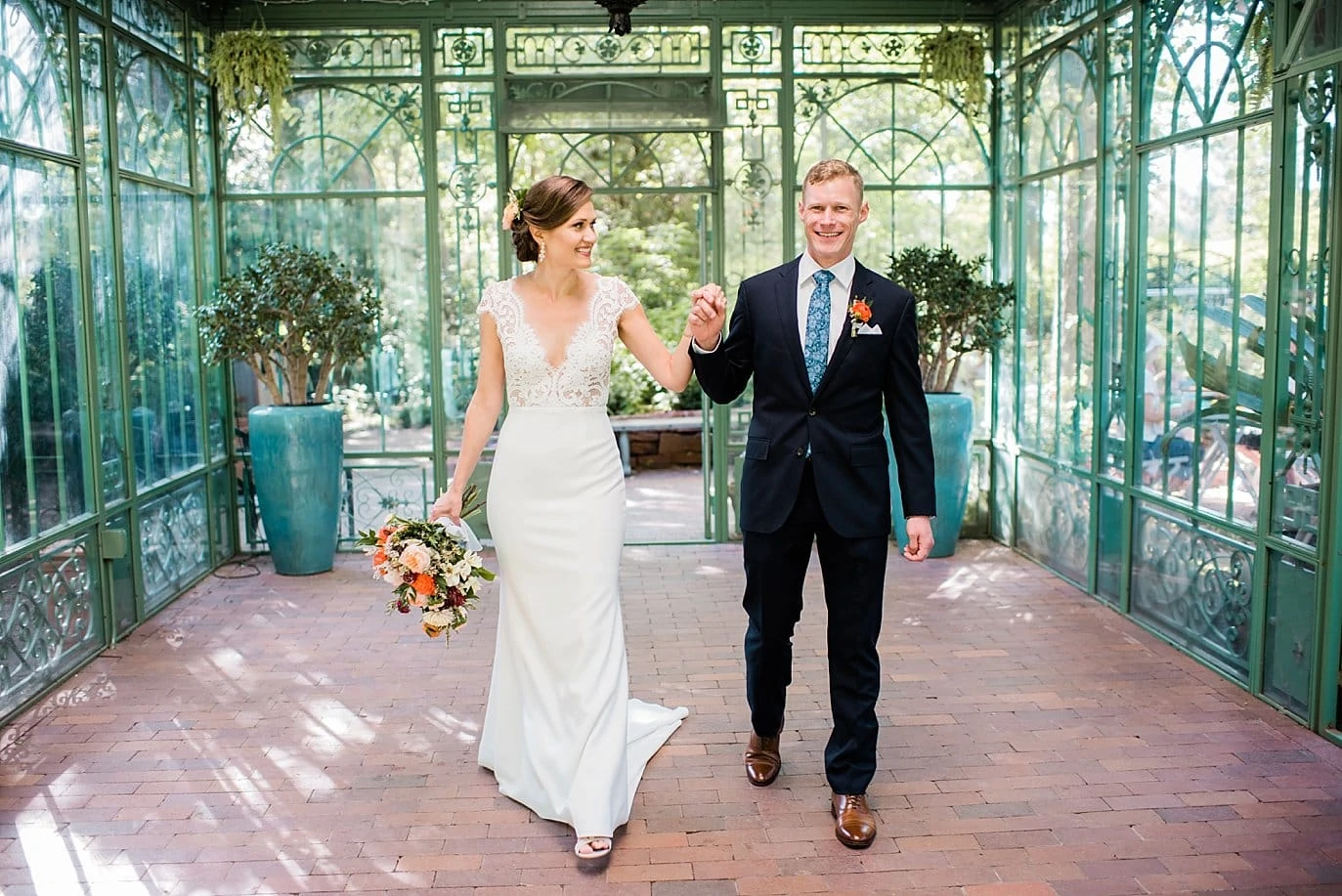 Bride and groom walk in green structure at Denver Botanic Gardens Wedding by Denver Wedding Photographer Jennie Crate