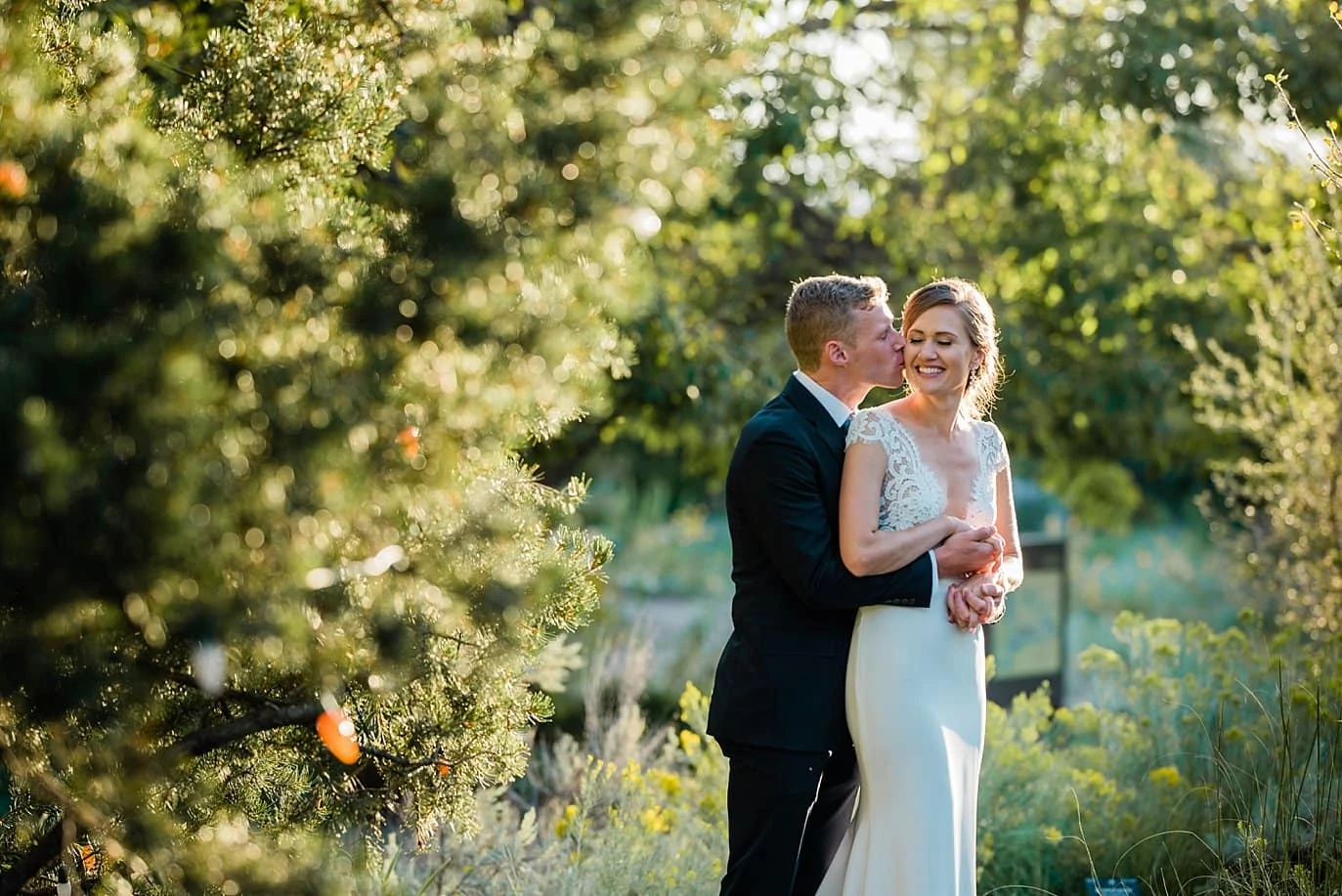 bride and groom sunset portraits vat Denver Botanic Gardens wedding by Denver Wedding Photographer Jennie Crate