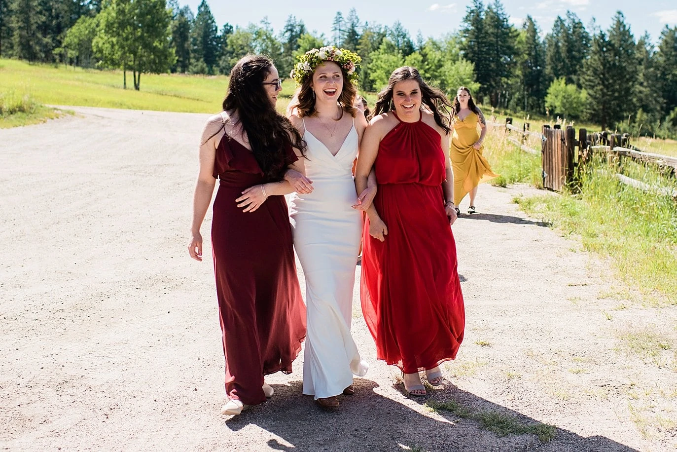 bride and bridesmaids walking to ceremony colorado outdoor wedding photo